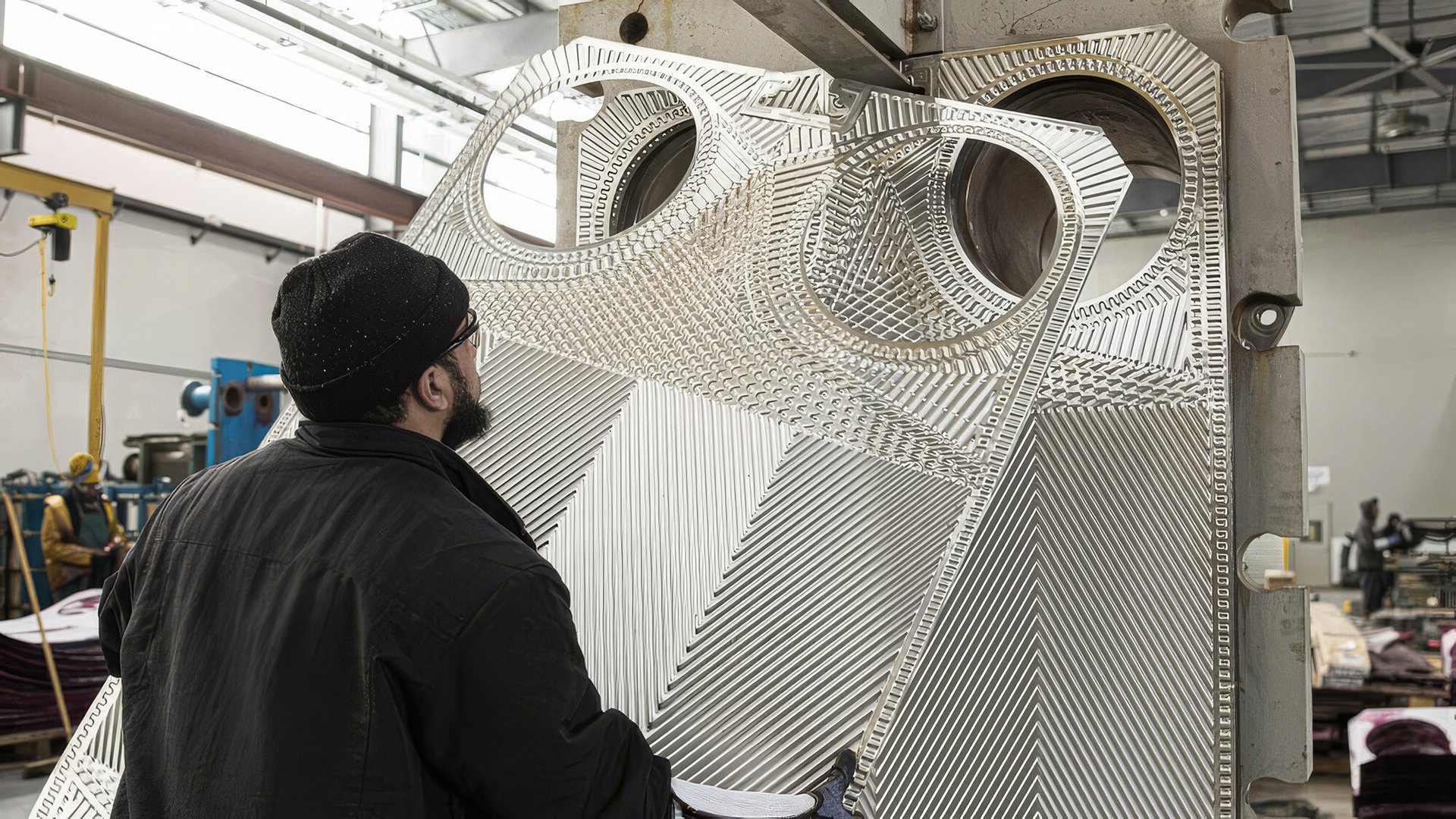 man handling plates for plate heat exhanger
